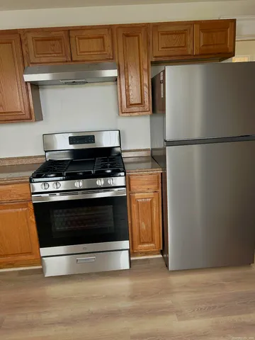 a kitchen with wooden cabinets and a stove top oven