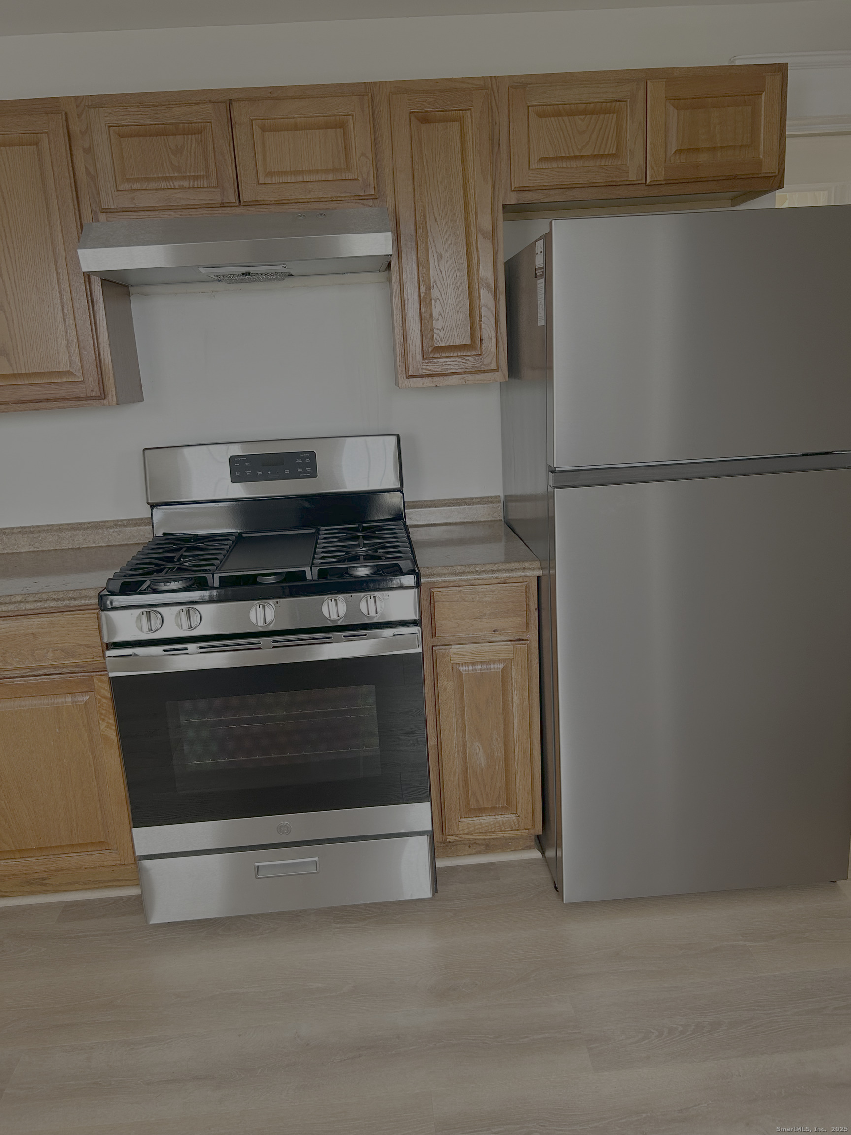 64 Lexington Street Hamden, CT 06514 - Photo 4 of 6 a kitchen with wooden cabinets and a stove top oven