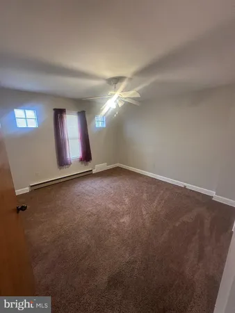 an empty room with a empty space and windows