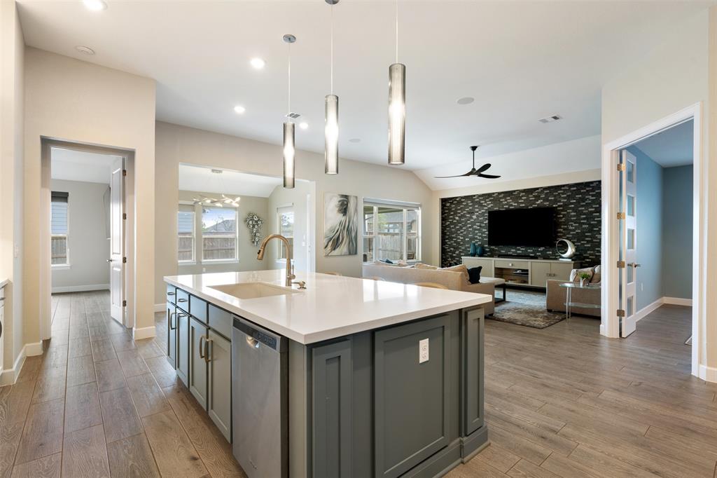 1012 Quarry Point Pass Leander, TX 78641 - Photo 9 of 39 An open-concept living area with a well-appointed kitchen island, perfect for entertaining.