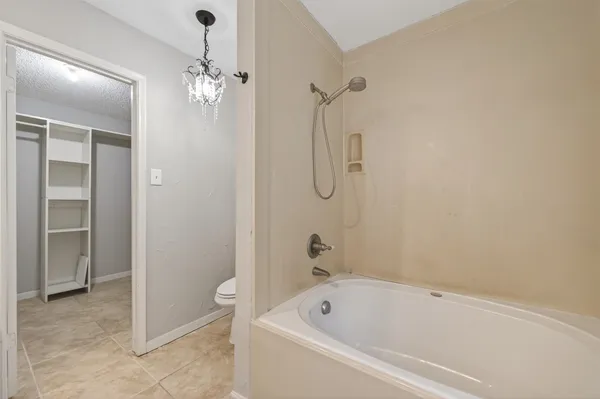 a bathroom with a bathtub a toilet and a shower