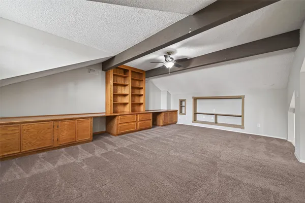 a view of an empty room with windows