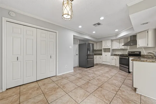 a kitchen with stainless steel appliances granite countertop a refrigerator and a sink