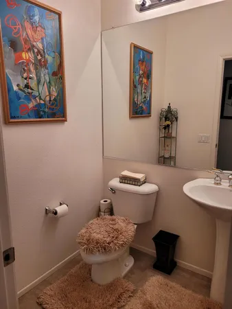 a bathroom with a toilet sink and mirror