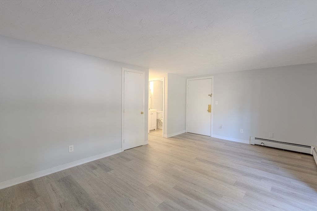 5 Tideview Path, Unit 4 Plymouth, MA 02360 - Photo 11 of 16 a view of an empty room and wooden floor