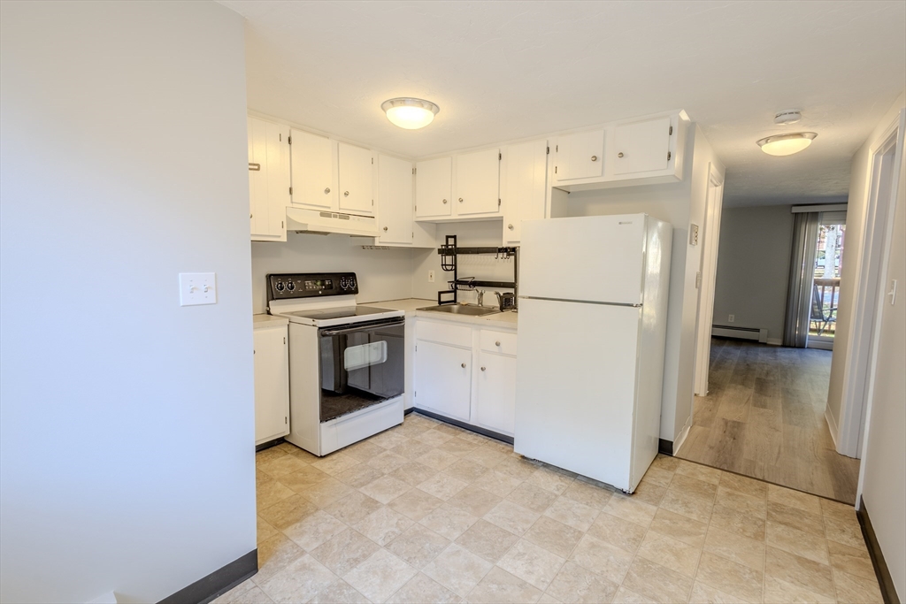 5 Tideview Path, Unit 4 Plymouth, MA 02360 - Photo 2 of 16 a kitchen with a refrigerator a stove top oven and a refrigerator
