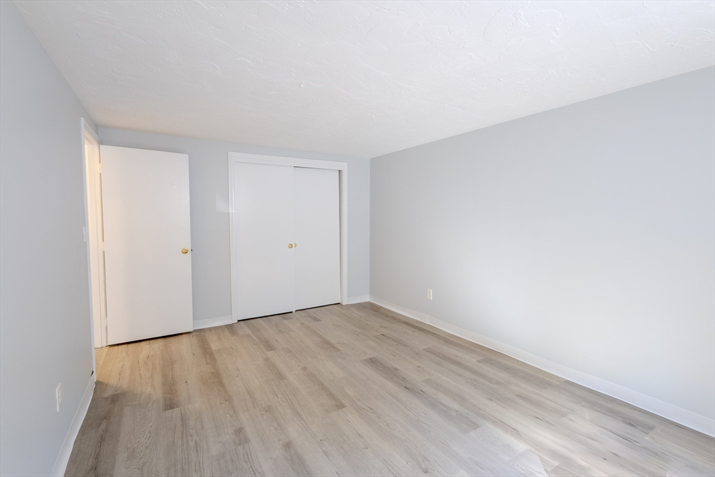 5 Tideview Path, Unit 4 Plymouth, MA 02360 - Photo 7 of 16 a view of an empty room with wooden floor