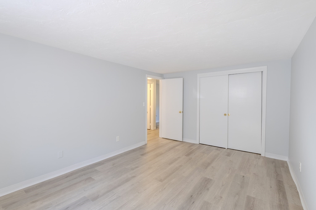 5 Tideview Path, Unit 4 Plymouth, MA 02360 - Photo 8 of 16 a view of an empty room and wooden floor