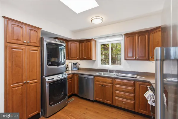 a kitchen with stainless steel appliances granite countertop a refrigerator stove and sink