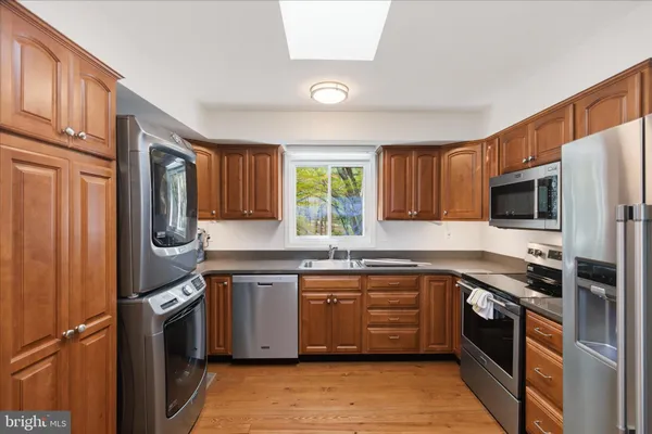 a kitchen with stainless steel appliances granite countertop a refrigerator stove and microwave
