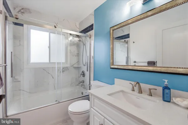 a bathroom with a sink vanity and mirror