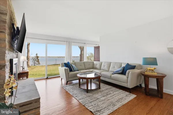 a living room with furniture wooden floor and a flat screen tv