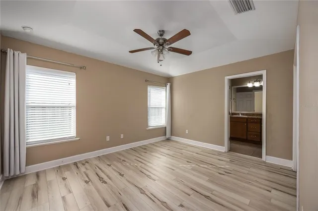 a view of a livingroom with a window and wooden floor