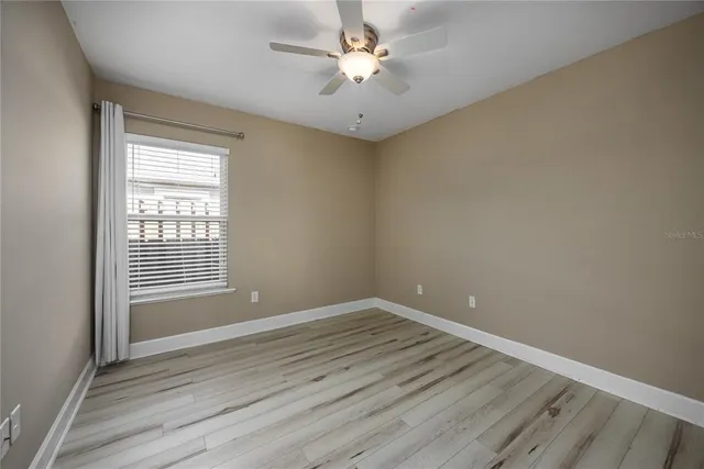 wooden floor in an empty room with a window