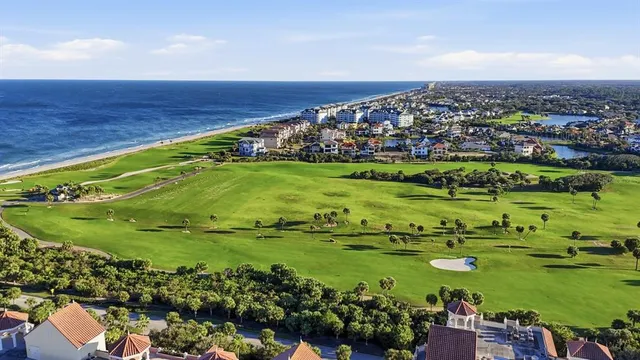 a view of a swimming pool with a patio and a garden