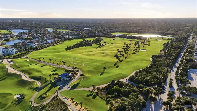 a view of a swimming pool with a lawn chairs under an umbrella