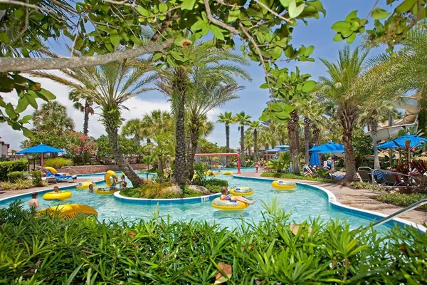 a view of a fountain in front of the house with a yard