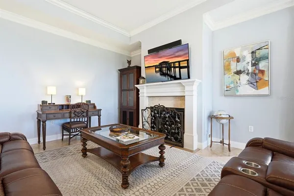a living room with furniture a fireplace and a large window
