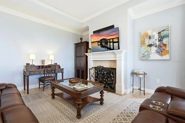 a living room with furniture a fireplace and a large window