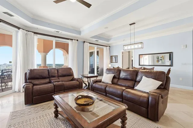 a living room with furniture a flat screen tv and a window