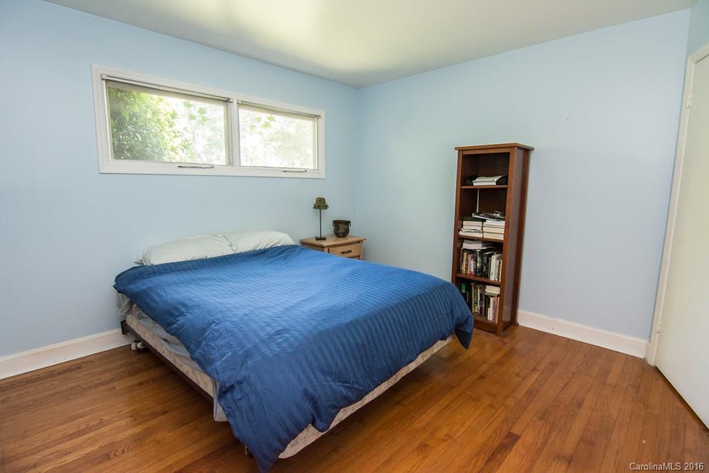 7424 Watercrest Road, Unit 14 Charlotte, NC 28210 - Photo 14 of 21 a bedroom with a bed and wooden floor