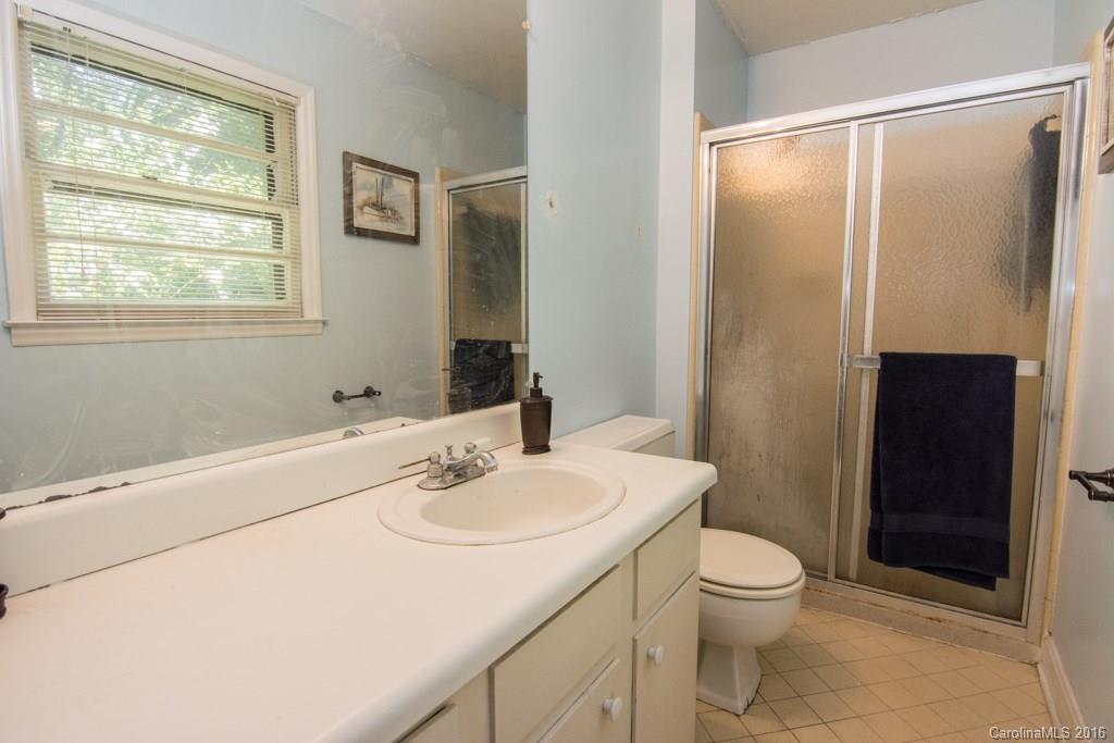 7424 Watercrest Road, Unit 14 Charlotte, NC 28210 - Photo 18 of 21 a bathroom with a sink a toilet and shower