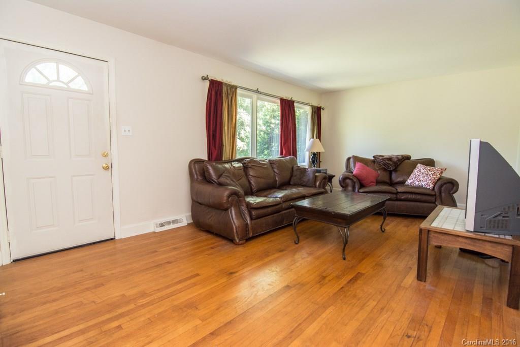 7424 Watercrest Road, Unit 14 Charlotte, NC 28210 - Photo 3 of 21 a living room with furniture and a wooden floor