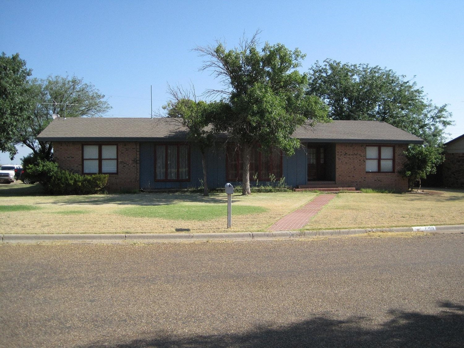 1201 17th Street Ralls, TX 79357 - Photo 1 of 10 a house that has a tree in front of it