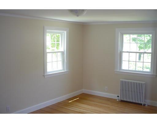 40 Clifton Road Milton, MA 02186 - Photo 7 of 9 an empty room with wooden floor and windows
