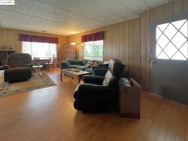 a living room with furniture window and wooden floor