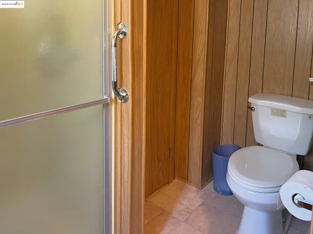 a bathroom with a toilet and a shower curtain