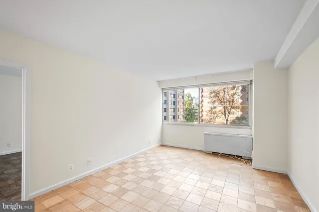 a spacious bathroom with a tub and mirror