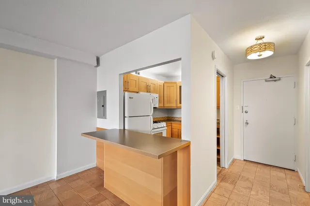 a white refrigerator freezer and a stove sitting inside of a kitchen
