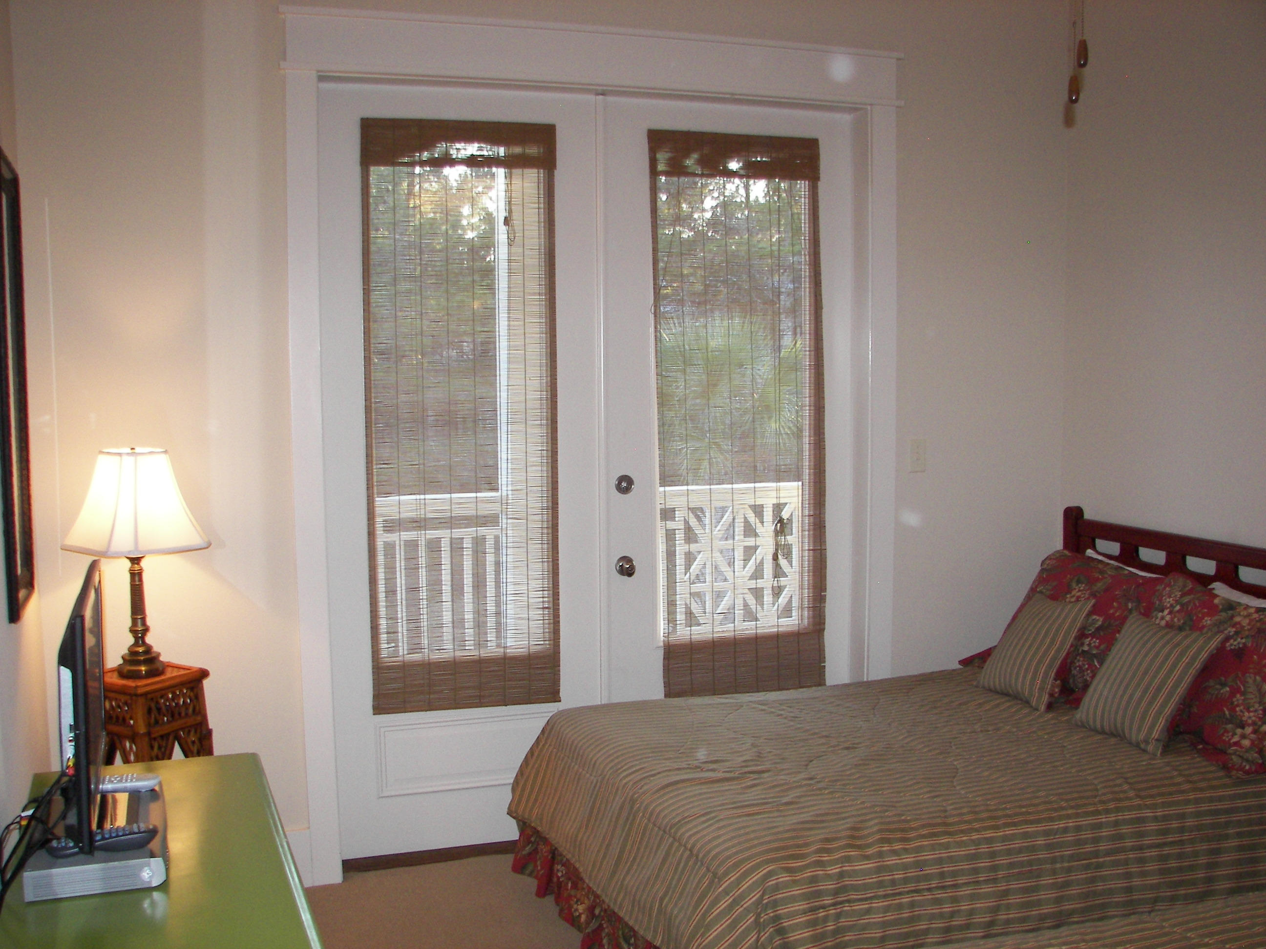 69 Lifeguard Loop West Inlet Beach, FL 32461 - Photo 30 of 34 a bedroom with a bed and a lamp next to a window