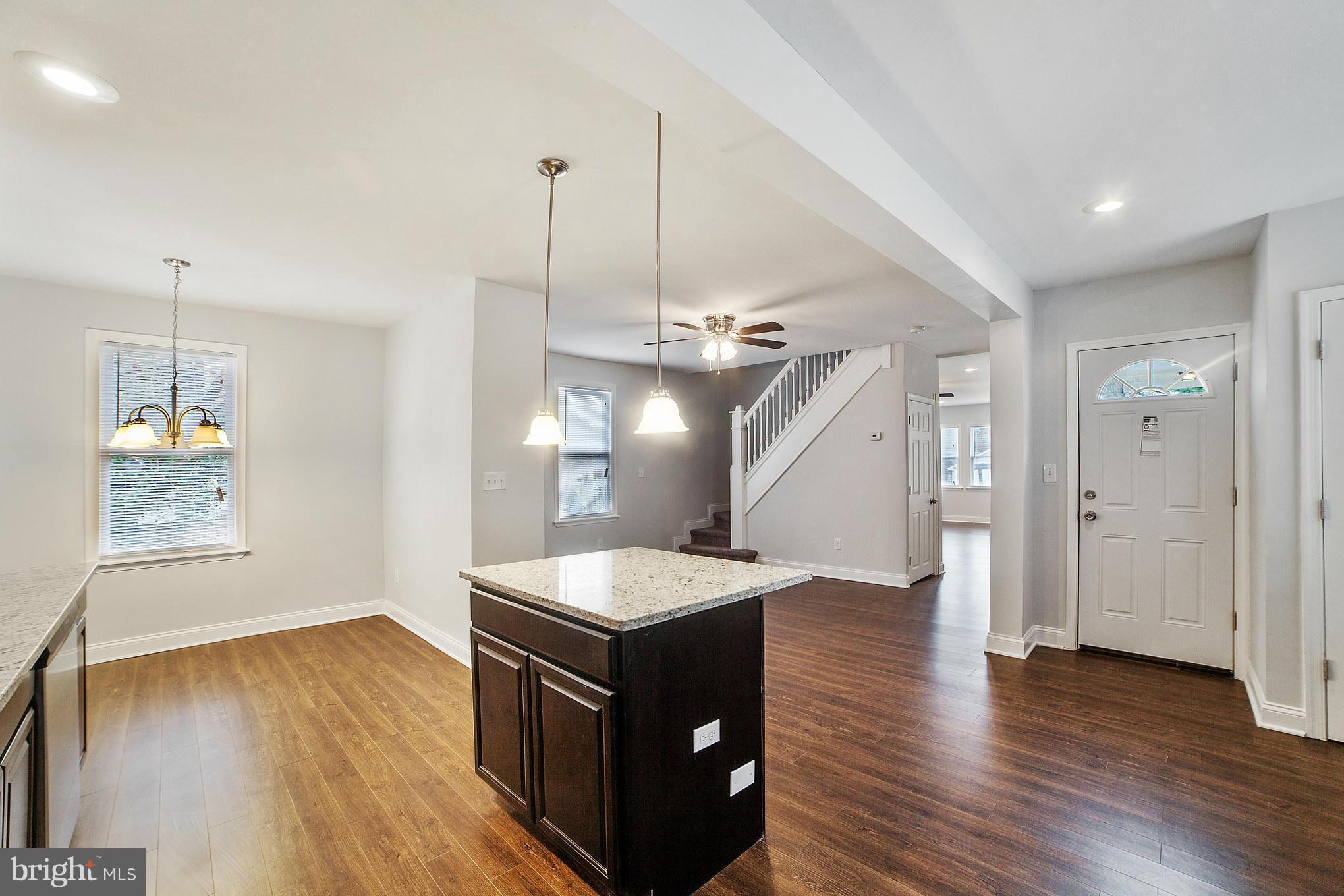 5502 Tramore Road Baltimore, MD 21214 - Photo 14 of 30 a kitchen with wooden floor and window