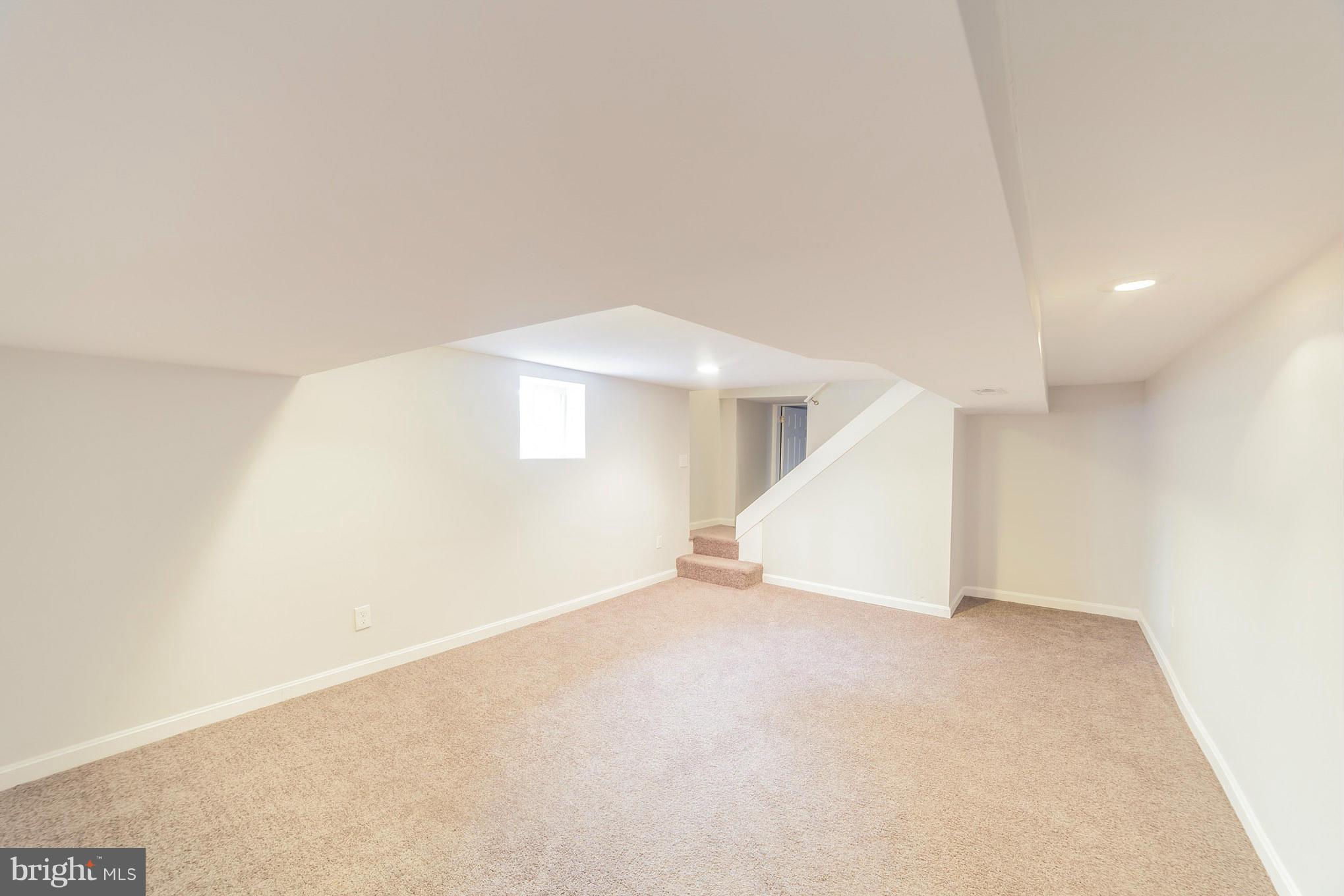5502 Tramore Road Baltimore, MD 21214 - Photo 16 of 30 an empty room with windows
