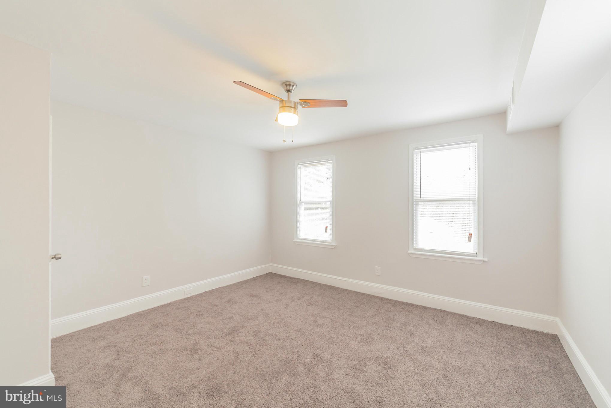 5502 Tramore Road Baltimore, MD 21214 - Photo 20 of 30 an empty room with windows and fan