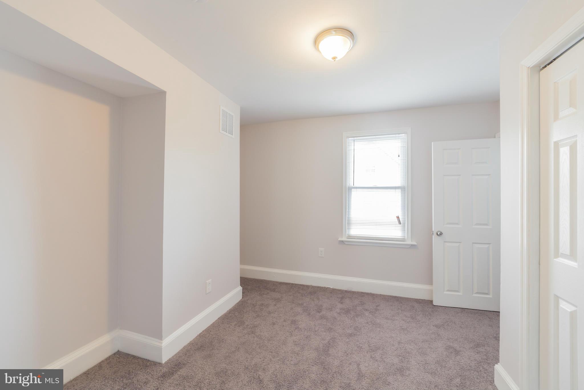 5502 Tramore Road Baltimore, MD 21214 - Photo 22 of 30 an empty room with windows