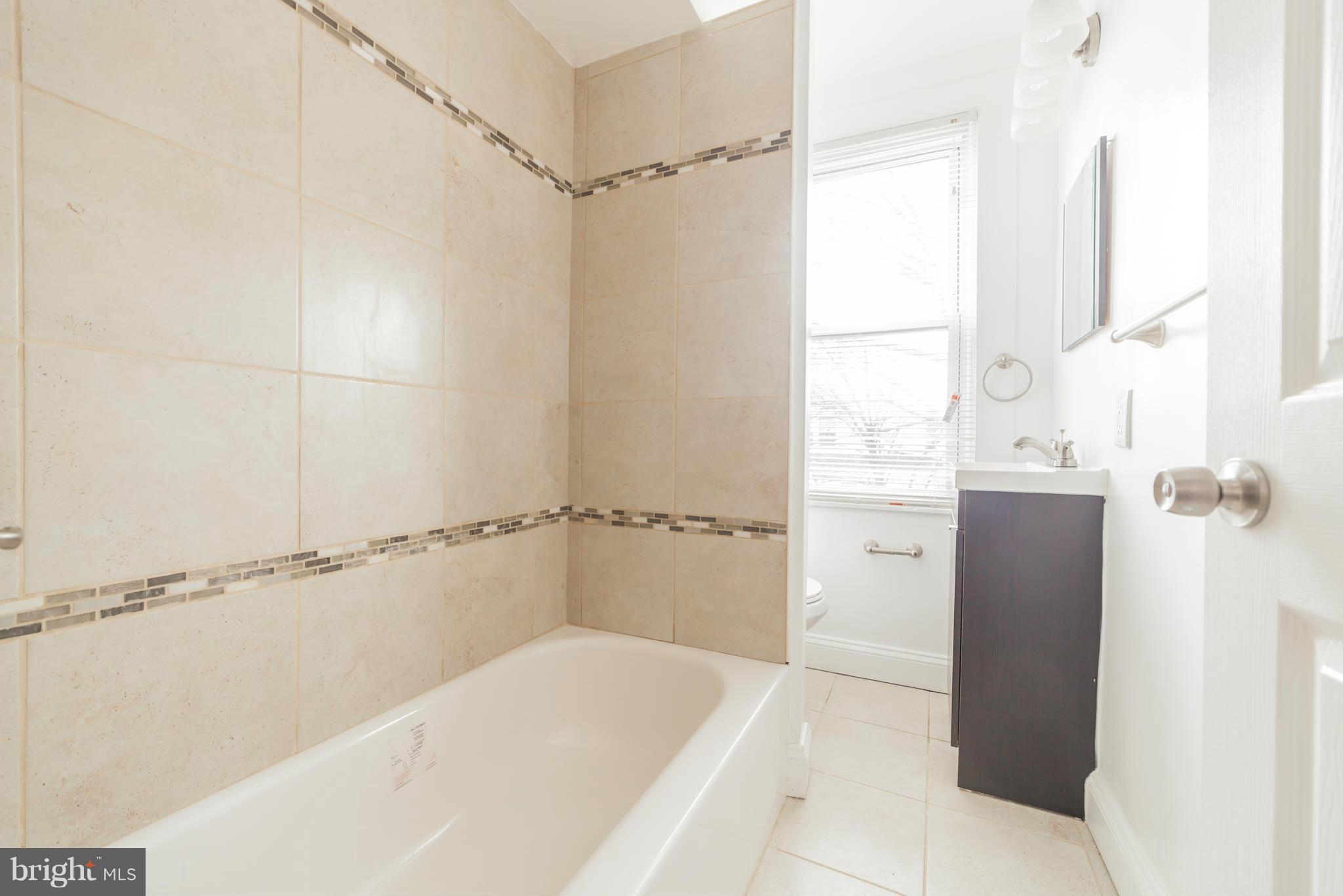 5502 Tramore Road Baltimore, MD 21214 - Photo 26 of 30 a bathroom with a bathtub and a shower