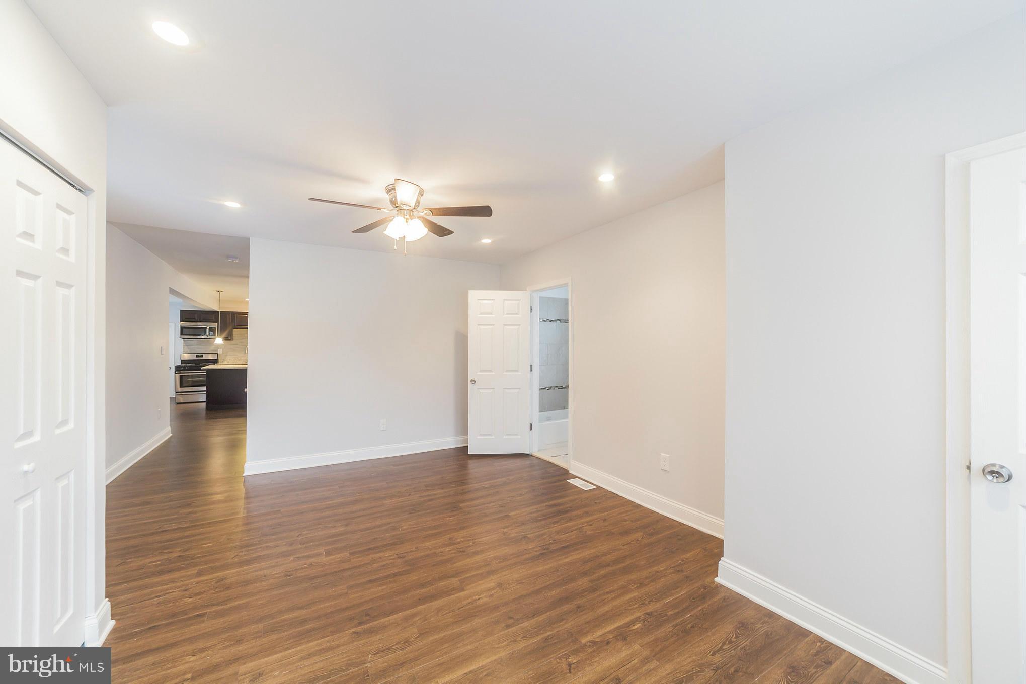 5502 Tramore Road Baltimore, MD 21214 - Photo 6 of 30 a view of an empty room with wooden floor