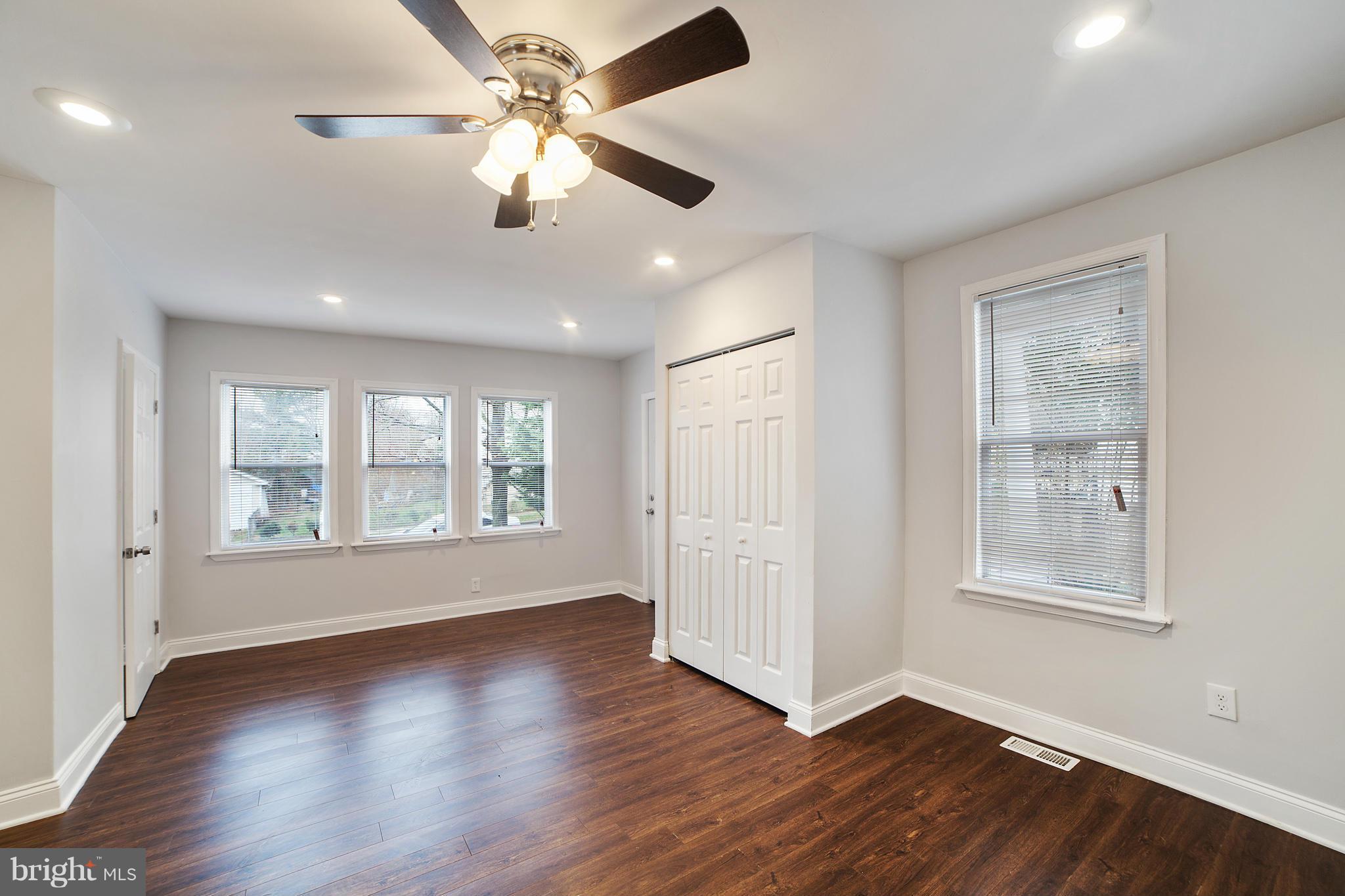 5502 Tramore Road Baltimore, MD 21214 - Photo 7 of 30 a view of an empty room with wooden floor and a window