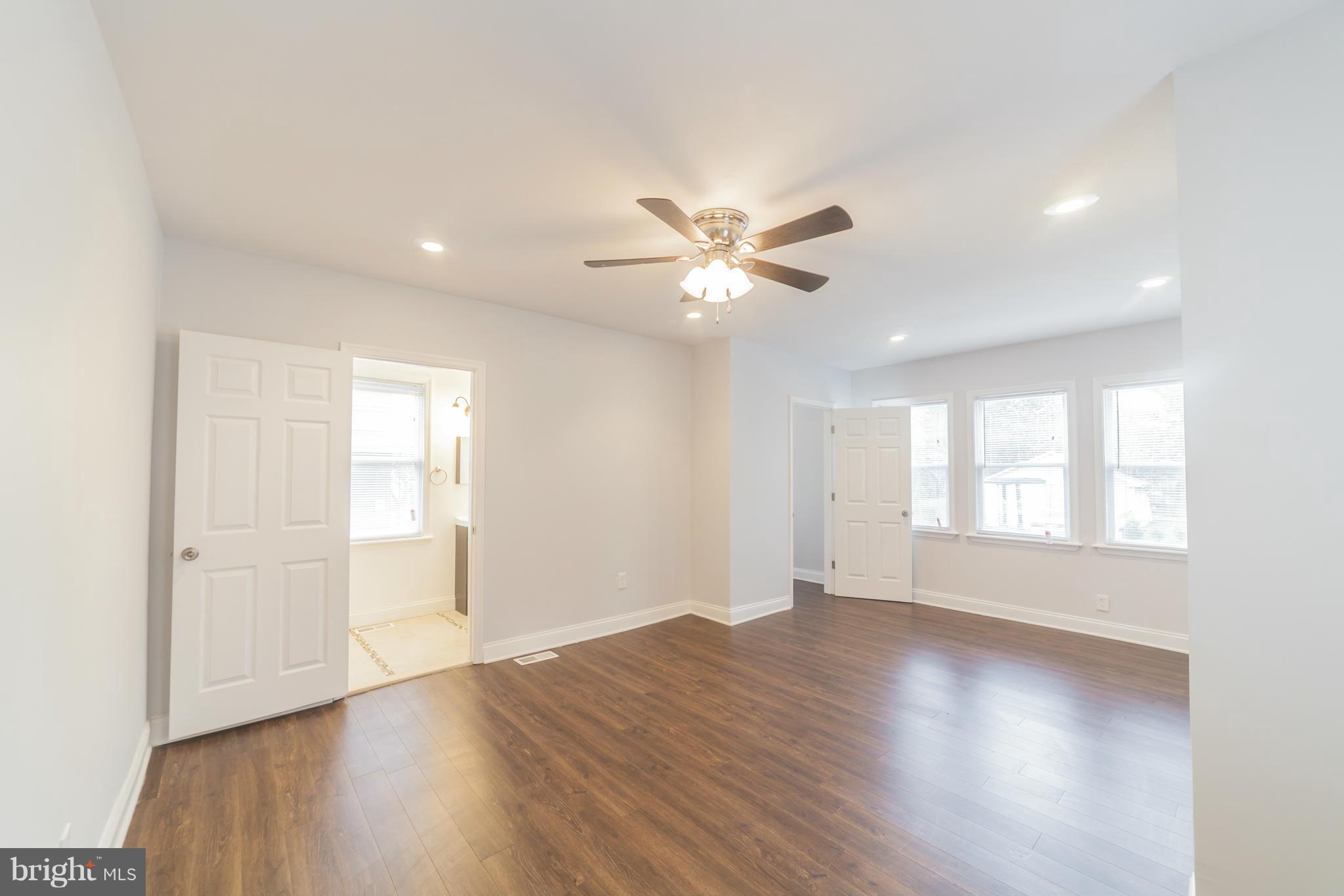 5502 Tramore Road Baltimore, MD 21214 - Photo 10 of 30 a view of an empty room with a window and wooden floor