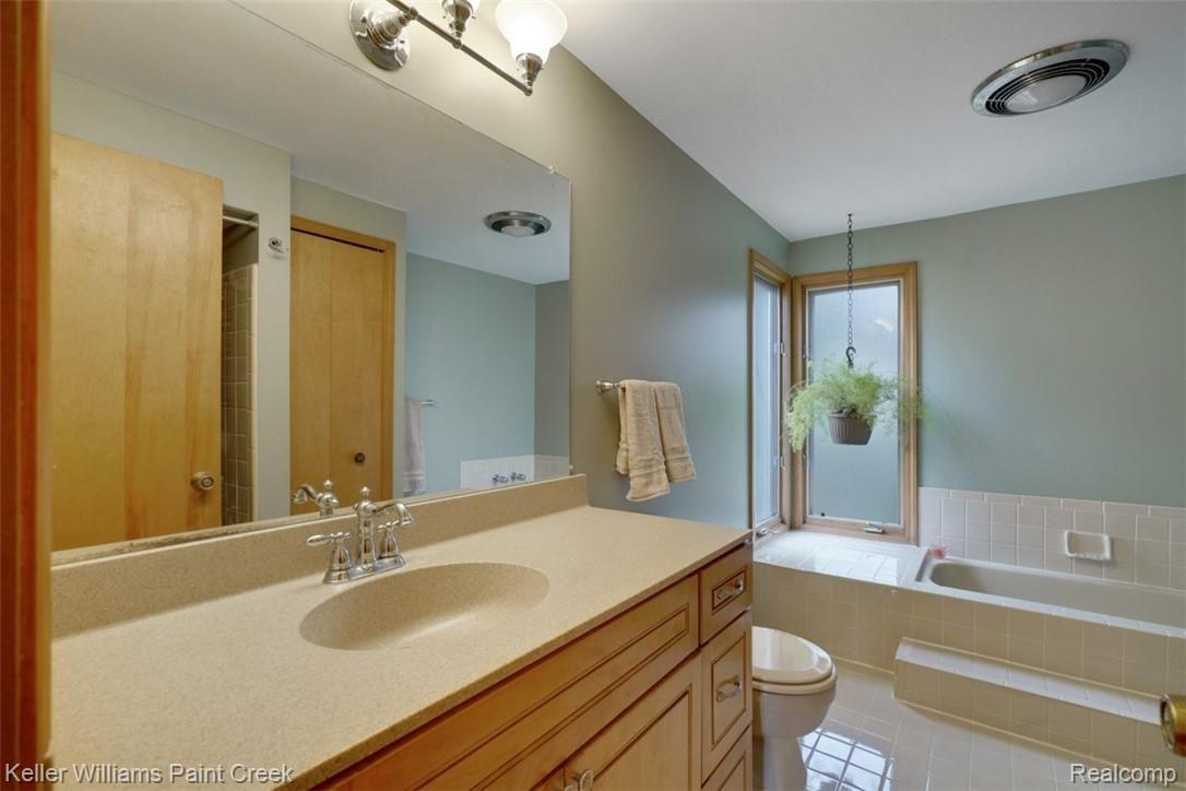 3098 Baypoint Drive Rochester, MI 48309 - Photo 25 of 32 Relax in the Large soaking tub with frosted windows in corner to allow natural light in. It also has an updated Master Bath vanity and walk in shower.