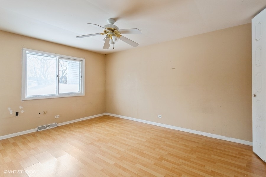 190 Roberts Road Bolingbrook, IL 60440 - Photo 11 of 15 a view of an empty room with wooden floor and a window
