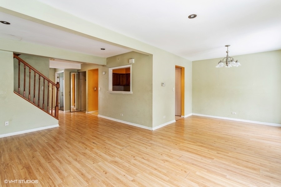190 Roberts Road Bolingbrook, IL 60440 - Photo 4 of 15 a view of an empty room with wooden floor and a window