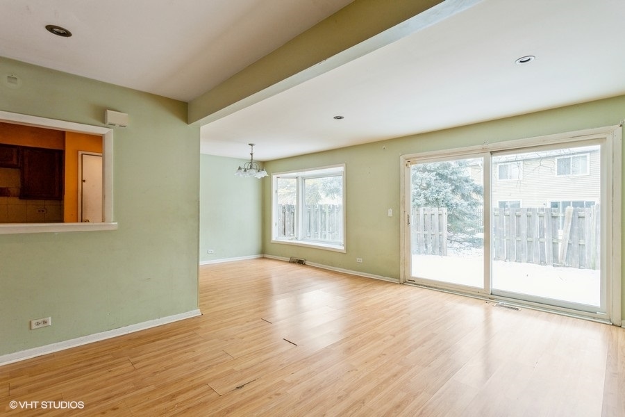 190 Roberts Road Bolingbrook, IL 60440 - Photo 6 of 15 a view of an empty room with wooden floor and a window