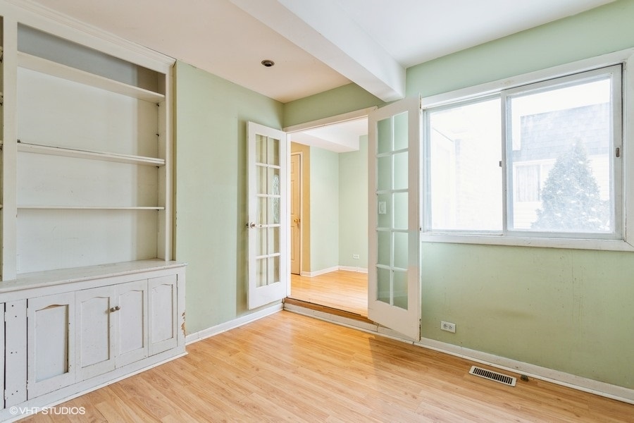 190 Roberts Road Bolingbrook, IL 60440 - Photo 7 of 15 a view of an empty room with wooden floor and a window