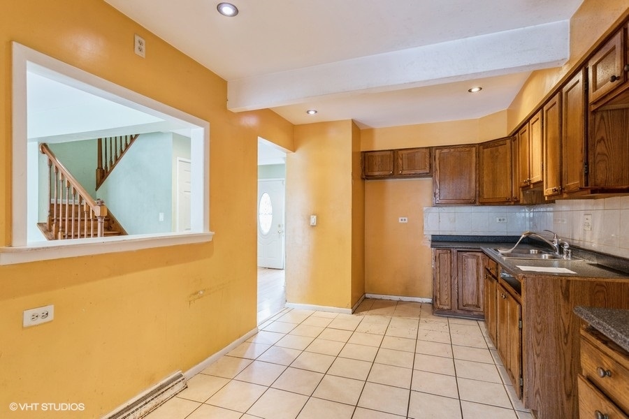 190 Roberts Road Bolingbrook, IL 60440 - Photo 10 of 15 a kitchen with a stove a sink and a refrigerator