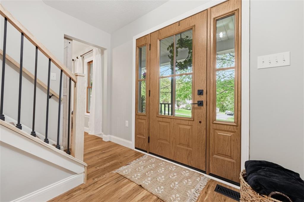 167 Wellington Road Aliquippa, PA 15001 - Photo 7 of 49 Beautiful new door welcomes you inside where you will find a totally updated home complete with new luxury vinyl flooring, new lighting, and new stair railings all tastefully done in a Modern Farmhouse Decor.