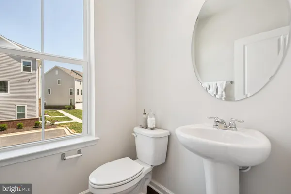 a bathroom with a sink a mirror and a toilet